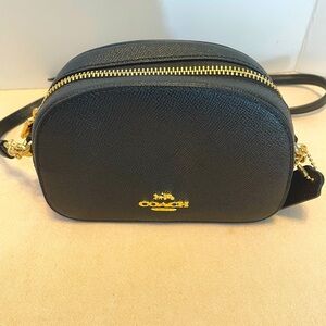 Coach. Coates canvas bag, black. Adjustable crossbody strap.